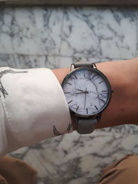 Cropped image of hand wearing wristwatch