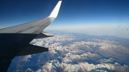 Aerial view of airplane wing over landscape