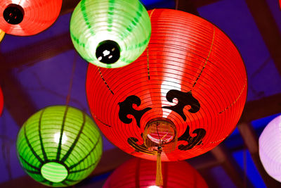 Low angle view of illuminated lanterns hanging at night