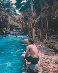 Man sitting on swimming pool