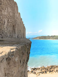 Scenic view of rocks on beach against sky