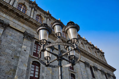 Low angle view of old building against blue sky