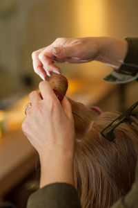 Close-up of woman holding hair home