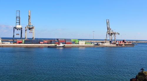 Commercial dock by sea against sky