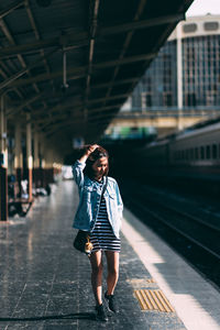 Full length of woman walking at railroad station