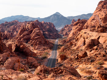 Scenic view of road amidst mountains against sky