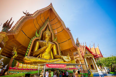 Low angle view of statue against temple building