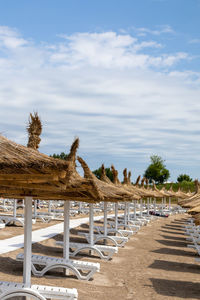 Sunbeds and umbrellas on the sandy beach, the summer season is ready for tourists