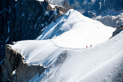 People on snowcapped mountain