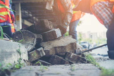 Man working on rocks at roadside