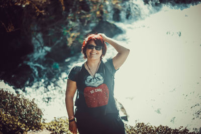 Portrait of young woman standing on land