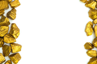 Directly above shot of yellow cake against white background