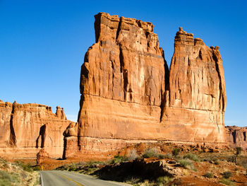 View of country road against clear blue sky