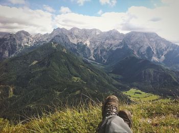 Low section of woman standing on mountain landscape