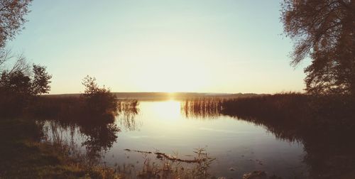 Scenic view of lake at sunset