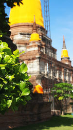 Close-up of yellow temple against sky