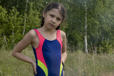 Girl in swimsuit in nature. outdoors, day light front view.