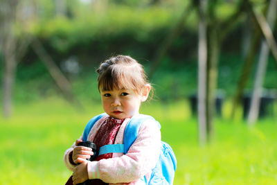 Portrait of cute girl standing in park