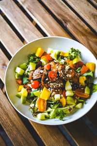 High angle view of chopped vegetables in bowl on table