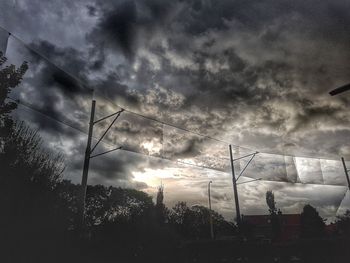 Silhouette landscape against cloudy sky