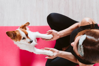 High angle view of woman with dog at home