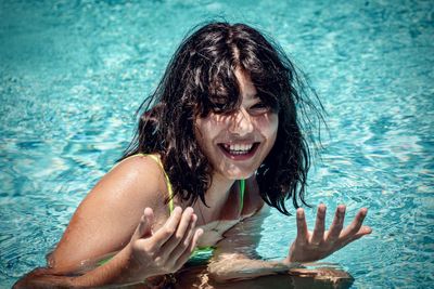 Portrait of young woman swimming in pool