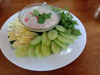 High angle view of chopped fruits in bowl on table