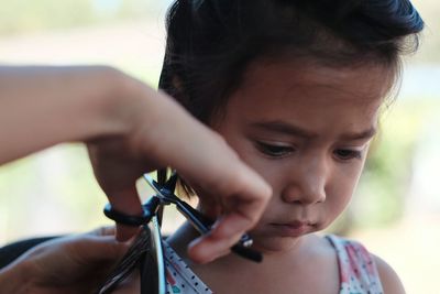 Close-up of girl holding hands