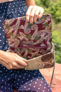 Girl holding a bag made of handmade python skin