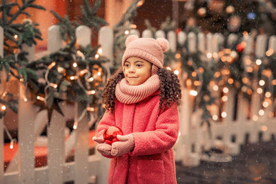 Portrait of smiling young woman standing outdoors