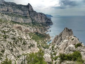 Rock formations by sea against sky