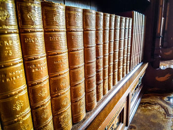 Close-up of books in shelf at home