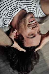 Portrait of young man lying down on floor