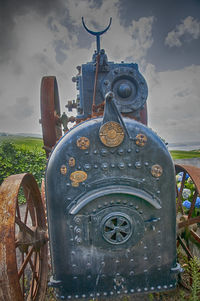 Close-up of coin-operated binoculars against sky