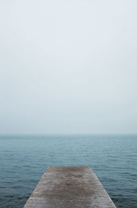 High angle view of jetty over sea against clear sky