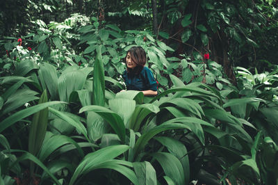 Woman amidst plants on field