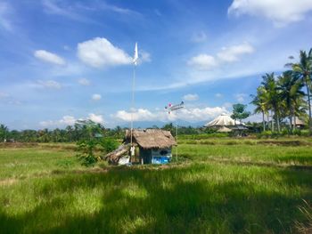 Scenic view of grassy field against cloudy sky