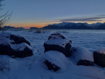 Scenic view of snow covered mountains against sky during sunset