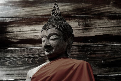 Portrait of buddha statue against temple