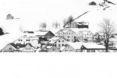 Houses against clear sky during winter