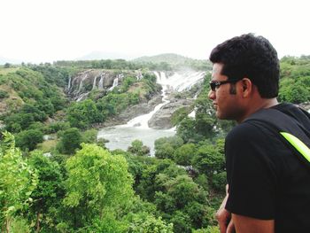 Portrait of young man standing on mountain