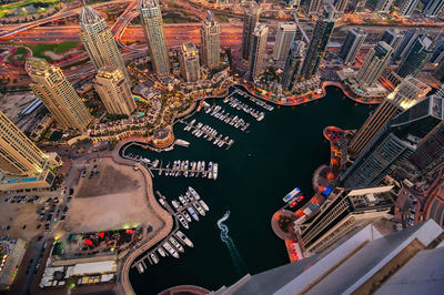 High angle view of city lit up at night