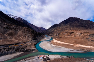 Panoramic view of mountain range against cloudy sky