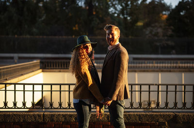 Young man standing by railing
