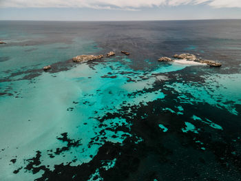 High angle view of sea shore against sky