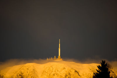 Lighthouse against sky at night