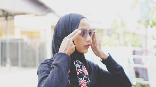 Portrait of young woman wearing sunglasses