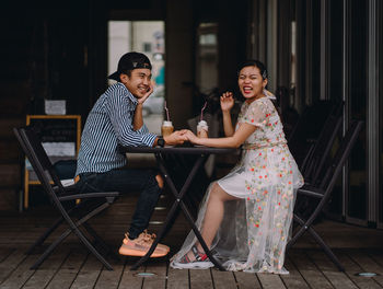 Young woman sitting on chair at home