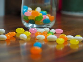 Close-up of multi colored candies in glass on table