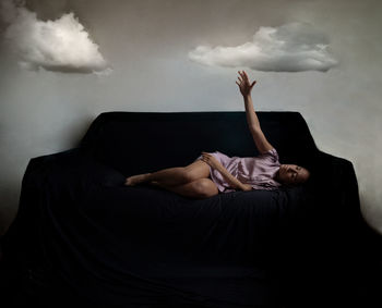 Digital composite image of woman lying down on sofa